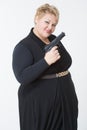 Fat woman with a gun. in a black dress Royalty Free Stock Photo