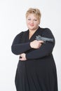 Fat woman with a gun. in a black dress Royalty Free Stock Photo