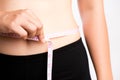 Fat woman hand measuring waist with white measuring tape, reducing excess weight. Healthcare and sport concept Royalty Free Stock Photo