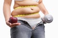 Fat woman holding apple and weight on each hand Royalty Free Stock Photo