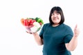 fat woman holding glass bowl  contains fruit and fresh vegetables On white background Royalty Free Stock Photo