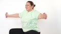 Fat woman making exercises with dumbbells