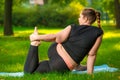 fat woman in the park doing yoga, plus size woman is very flexible