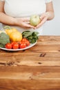 Fat woman snacking with fruits and vegetables Royalty Free Stock Photo