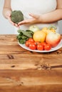 Fat woman snacking with fruits and vegetables Royalty Free Stock Photo