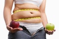 Fat woman with unzip jeans holding apple Royalty Free Stock Photo