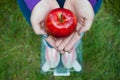 Fat woman wants to lose weight holds in hands folded boat red apple Royalty Free Stock Photo