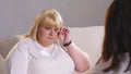 A fat woman complains to a dietician about her figure. Fat woman crying Royalty Free Stock Photo