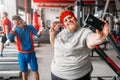 Fat woman makes selfie with instructor in gym Royalty Free Stock Photo