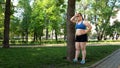 Fat young women resting after hard training in park, struggling with obesity