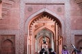 Beautiful sandstone hallway with people sitting