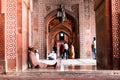 Beautiful sandstone hallway with people sitting