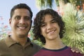 Father with Arm Around Son (13-15) front view portrait. Royalty Free Stock Photo