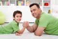 Father arm wrestling with his boy