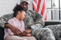 Father in army uniform and african american child