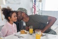 Father army uniform kissing african american daughter