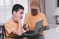 Father and asian disabled child on the wheelchair using notebook