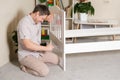 The father assembles the children's bed for the child, the man twists the screws into wooden furniture. Royalty Free Stock Photo