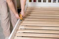 The father assembles the children's bed for the child, the man twists the screws into wooden furniture. Royalty Free Stock Photo