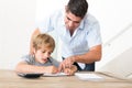 Father assisting son in homework Royalty Free Stock Photo