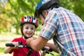 Father attaching his sons cycling helmet