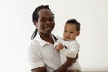 Father And Baby. Black Dad Posing With Adorable Toddler Child In Hands Royalty Free Stock Photo