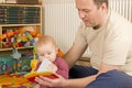 Father, baby and a book