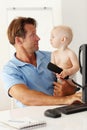 Father, baby and computer for remote work in home with desktop, communication and multitasking. Man, young male child Royalty Free Stock Photo