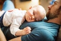 Father with a baby girl at home sleeping. Royalty Free Stock Photo