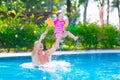 Father and baby girl playing in a swimming pool Royalty Free Stock Photo