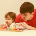 Father and baby girl playing xylophone toy Royalty Free Stock Photo