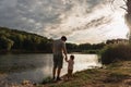 Father and baby girl sitting near lake. Local travel. New normal vacation. Father`s day Royalty Free Stock Photo