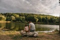 Father and baby girl sitting near lake. Local travel. New normal vacation. Father`s day Royalty Free Stock Photo