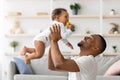 Father Baby Relationship. Happy Black Man Lifting Up His Adorable Infant Son Royalty Free Stock Photo