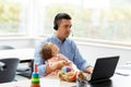 Father with baby working on laptop at home office Royalty Free Stock Photo