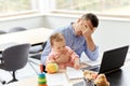 Father with baby working on laptop at home office Royalty Free Stock Photo