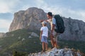 Father with backpack and son in the mountains