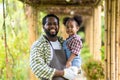 Father with beard holding his Daughter in his arms looking at him with love in rainy