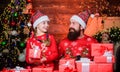 Father bearded man and daughter near christmas tree. Spend time with family. Dad and child opening christmas gifts. All Royalty Free Stock Photo