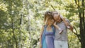 Father - bold man, mother - blonde beautiful woman and little girl - walking in the park at sunny day Royalty Free Stock Photo