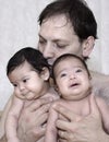 Father bonding with baby twins Royalty Free Stock Photo