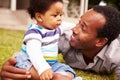 Father bonding with his toddler son in a garden