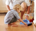 Father with boy child sweeping up mess, family cleaning together and help with broom and dustpan. Hygiene, chores and