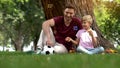 Father and boy enjoying making bubbles in park, family entertainment in weekend