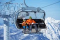 Father and boy sit in ski lift over mountains Royalty Free Stock Photo