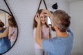 Father brushing his little daughter& x27;s hair in bathroom, morning routine concept. Royalty Free Stock Photo