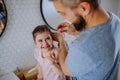 Father brushing his little daughter& x27;s hair in bathroom, morning routine concept. Royalty Free Stock Photo