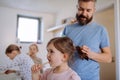 Father brushing his little daughter& x27;s hair in bathroom, morning routine concept. Royalty Free Stock Photo