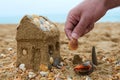 Father building a sand house on a seashore