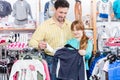 Father buying clothes for his daughter